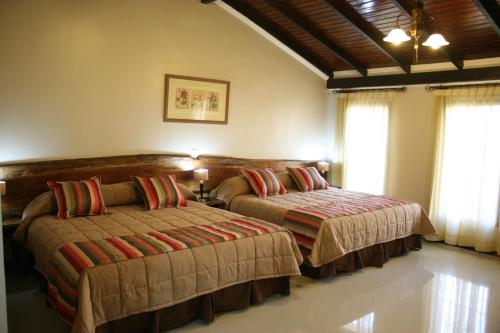 Ένα ή περισσότερα κρεβάτια σε δωμάτιο στο Posada del Jacarandá