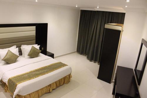 a bedroom with a large bed in a room at SHALLY RESIDENCE 1 in Al Khobar