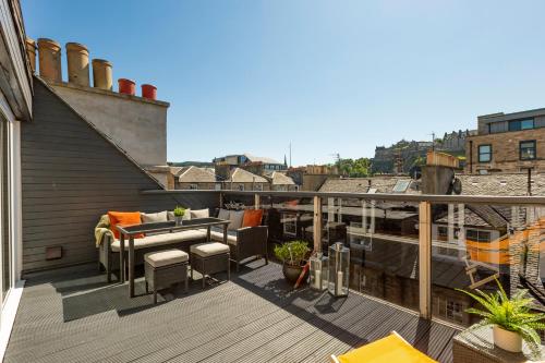 a balcony with a table and chairs on a building at The Edinburgh Rooftop Terrace in Edinburgh