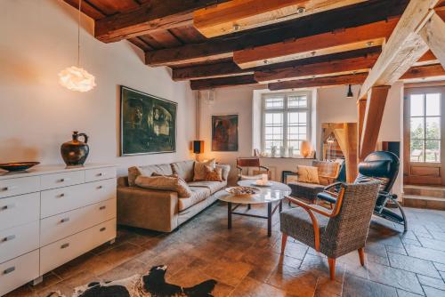 a living room with a couch and a table at Óbester Panzió in Badacsonytomaj