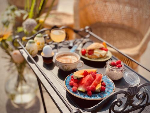 a table with plates of fruit and desserts on it at Fröken Hjorts Bed and Breakfast in Höganäs
