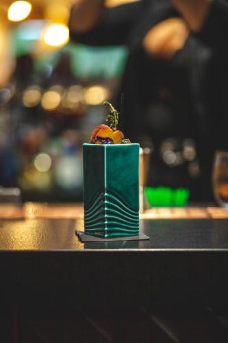a fruit in a green container sitting on a counter at Hotel Du Lac in Montriond