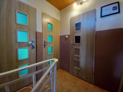 a hallway with two doors and a staircase at Pokoje Gościnne u Marysi in Nowy Sącz