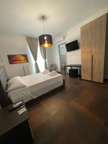a bedroom with a bed and a cabinet and a table at Relais Petruzzelli in Bari