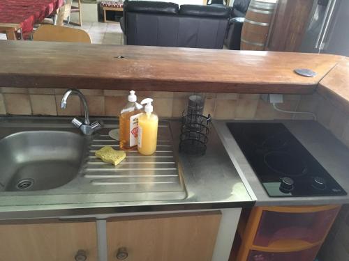a kitchen sink with two bottles of orange juice on it at Ferme Gite Equestre En Charente in Confolens