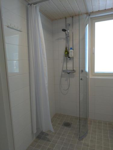 baño con ducha y puerta de cristal en Apartments Käyräkatu, en Jyväskylä