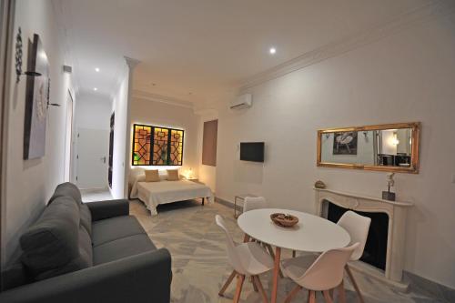 a living room with a couch and a table at Palacete Centro estilo Luxe in Jerez de la Frontera