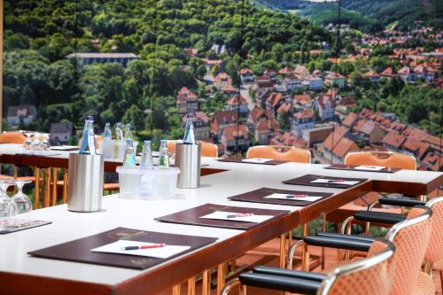a restaurant with tables and chairs with a view at Ringhotel Weißer Hirsch in Wernigerode
