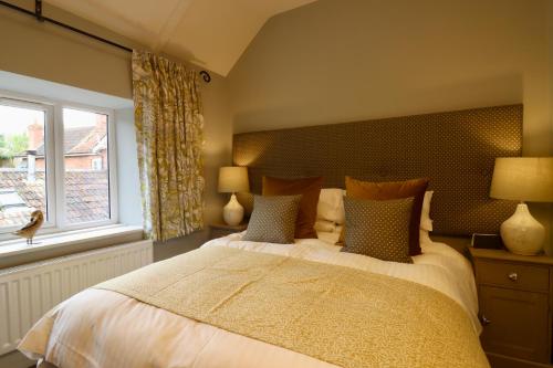 a bedroom with a large bed and a window at The New Inn Halse in Taunton