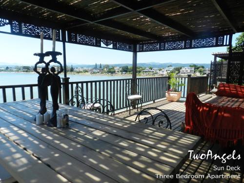 a statue of two people on a table on a deck at TwoAngels in Knysna