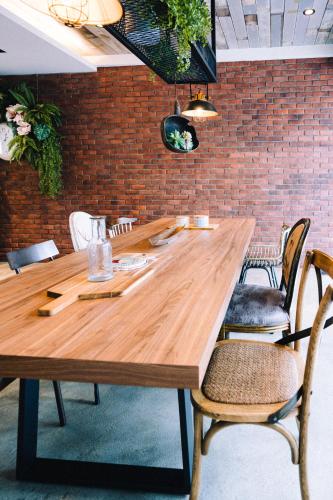 a large wooden table in a room with chairs at 雨禾田 in Sanxing