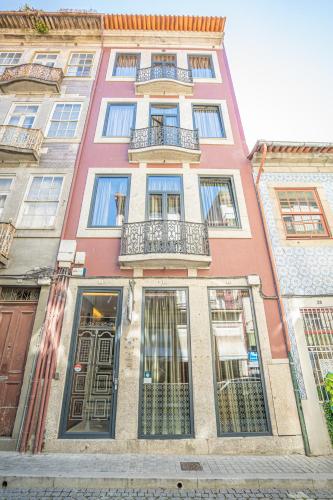 a tall building with windows and balconies on a street at CHARM by YoursPorto in Vila Nova de Gaia