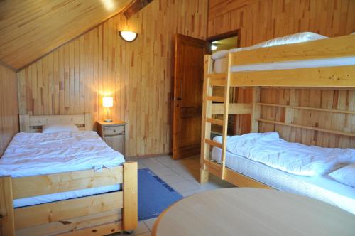 a bedroom with two bunk beds and a table at Gite Vivaldi in Durbuy