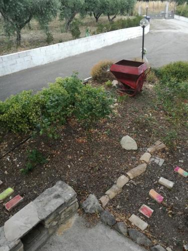 a garden with a red boat on the side of a road at B&B Pozzo Innamorato in Montenero di Bisaccia