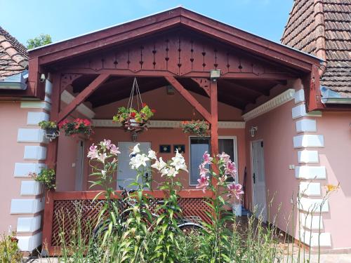 a house with a porch with flowers on it at Villa Sunset in Palić