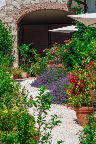 a garden with flowers and plants in front of a garage at Haus Diogenes in Mörbisch am See
