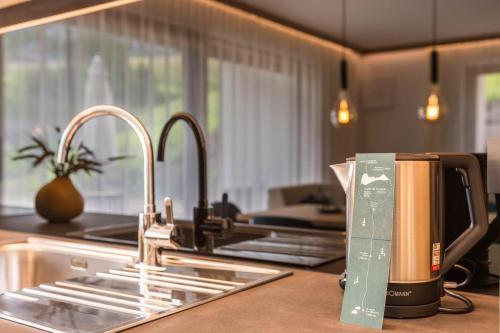 a kitchen counter with a sink and a coffee maker at Apt Lara Siela in Ortisei