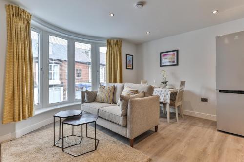 a living room with a couch and a table at Finest Retreats - 13 Belle House - Apartment 2 in Filey