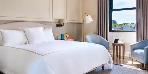 a hotel room with a white bed and a window at The Lansdowne Kenmare in Kenmare