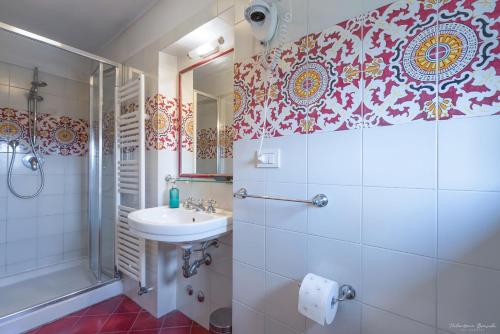 a bathroom with a sink and a shower at Villa Ape Rosa Relais in Florence