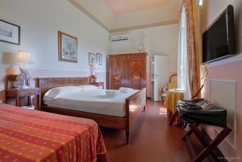 a bedroom with a bed and a flat screen tv at Villa Ape Rosa Relais in Florence