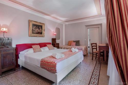 a bedroom with a bed and a table and chairs at Villa Ape Rosa Relais in Florence
