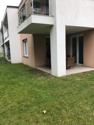a white house with a lawn in front of it at LIDO nappali + 3 háló apartman in Balatonlelle