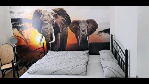 a bedroom with a mural of two elephants on the wall at Joanna Apartment - MA Rheinau 2 in Mannheim