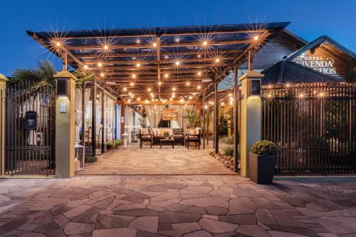 a pergola with lights and a patio at Hotel Vivenda dos Sonhos in Gramado
