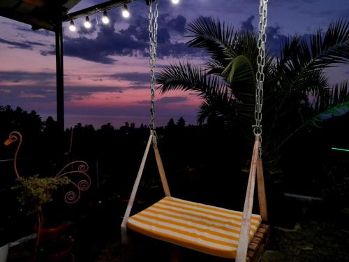 a hammock swing with a sunset in the background at Kemeni Gardens in Batumi