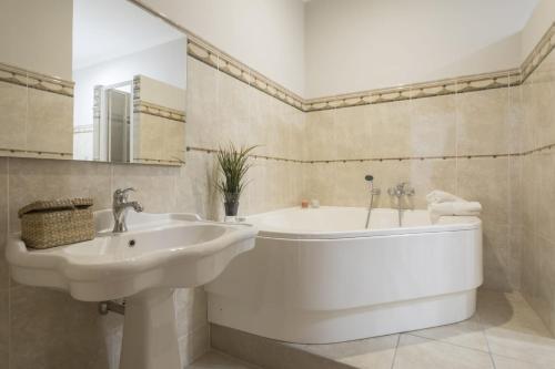 a bathroom with a sink and a bath tub at A vista ri luocci in Modica
