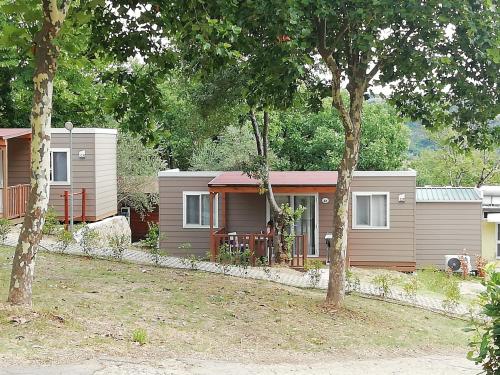 a small house with trees in front of it at hu Firenze Certosa camping in town in Impruneta