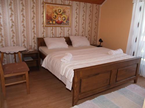 a bedroom with a bed and a chair at Jelena in Korenica