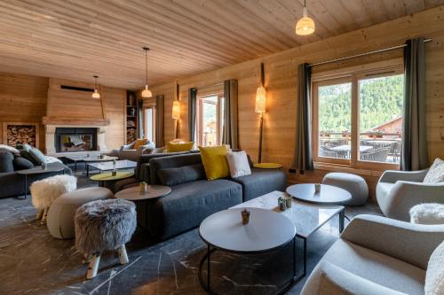 a living room filled with furniture and a fireplace at Le Chalet Blanc Hôtel & Spa in Montgenèvre