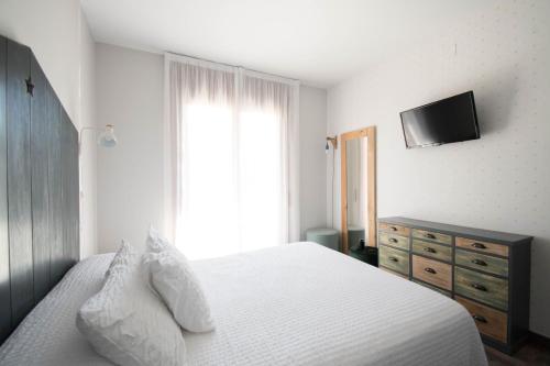 Ένα ή περισσότερα κρεβάτια σε δωμάτιο στο Hotel Casa Cauma