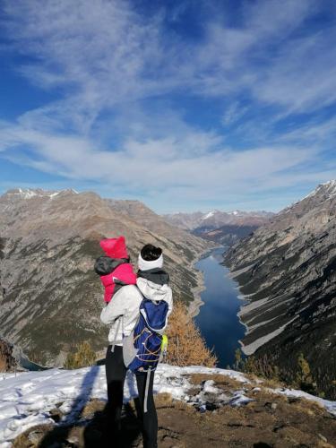 a man holding a child on top of a mountain at Hotel Galli in Livigno