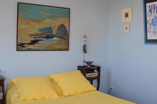 ValaurieにあるECOLE DES GRANDSのベッドルーム1室(ベッド1台付)が備わります。壁には絵画が飾られています。