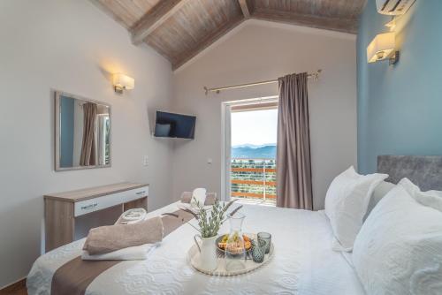 a bedroom with a bed with a table with fruit on it at Koumaries Villas in Lygia