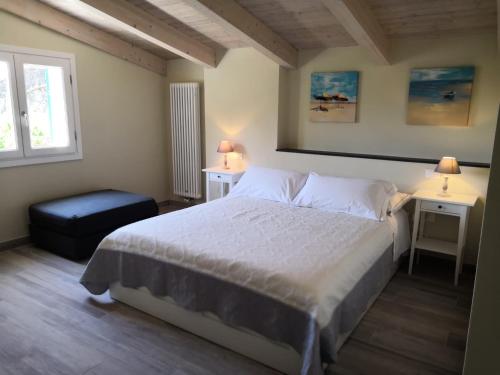 a bedroom with a bed and two tables and a window at Camere Toni in Vernazza