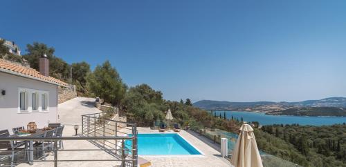 a villa with a swimming pool and a view of the water at Koumaries Villas in Lygia