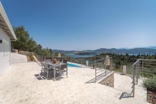 a patio with a table and a view of the water at Koumaries Villas in Lygia