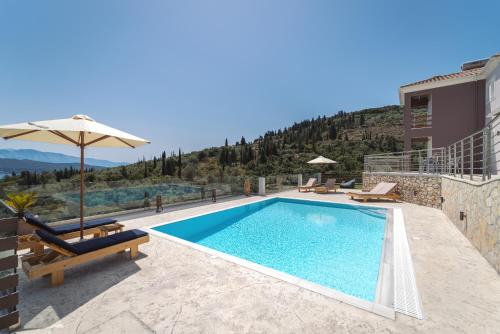 a villa with a swimming pool on top of a building at Koumaries Villas in Lygia