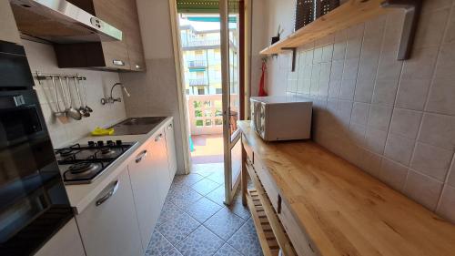 a kitchen with a sink and a stove top oven at Luogo di Pace in Grado