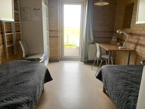 Postel nebo postele na pokoji v ubytování Danhostel Fjaltring