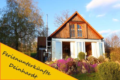 a house with a sign in front of it at Ferienunterkünfte Deinhardt in Poxdorf