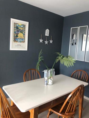 a dining room with a white table and chairs at Edificio Soles in Puerto Madryn