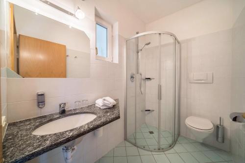 a bathroom with a sink and a shower and a toilet at Weinsepphof Ferienwohnung 8 in Lana