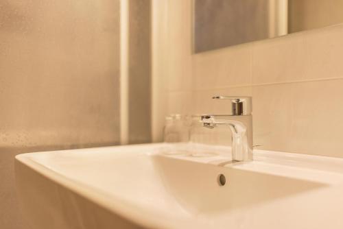 a white sink with a faucet in a bathroom at Apt Hofer Heidi in Villabassa