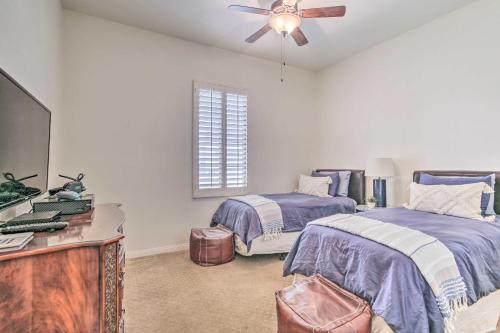 Un dormitorio con dos camas y un ventilador de techo. en Desert Views and Pool Access Home in La Quinta!, en La Quinta
