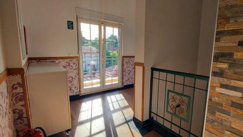 an empty room with a large window and a kitchen at Hotel Blagaj Mostar in Blagaj